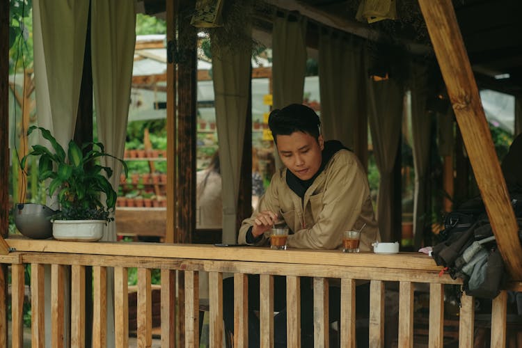 Man Stirring Tea In Cup