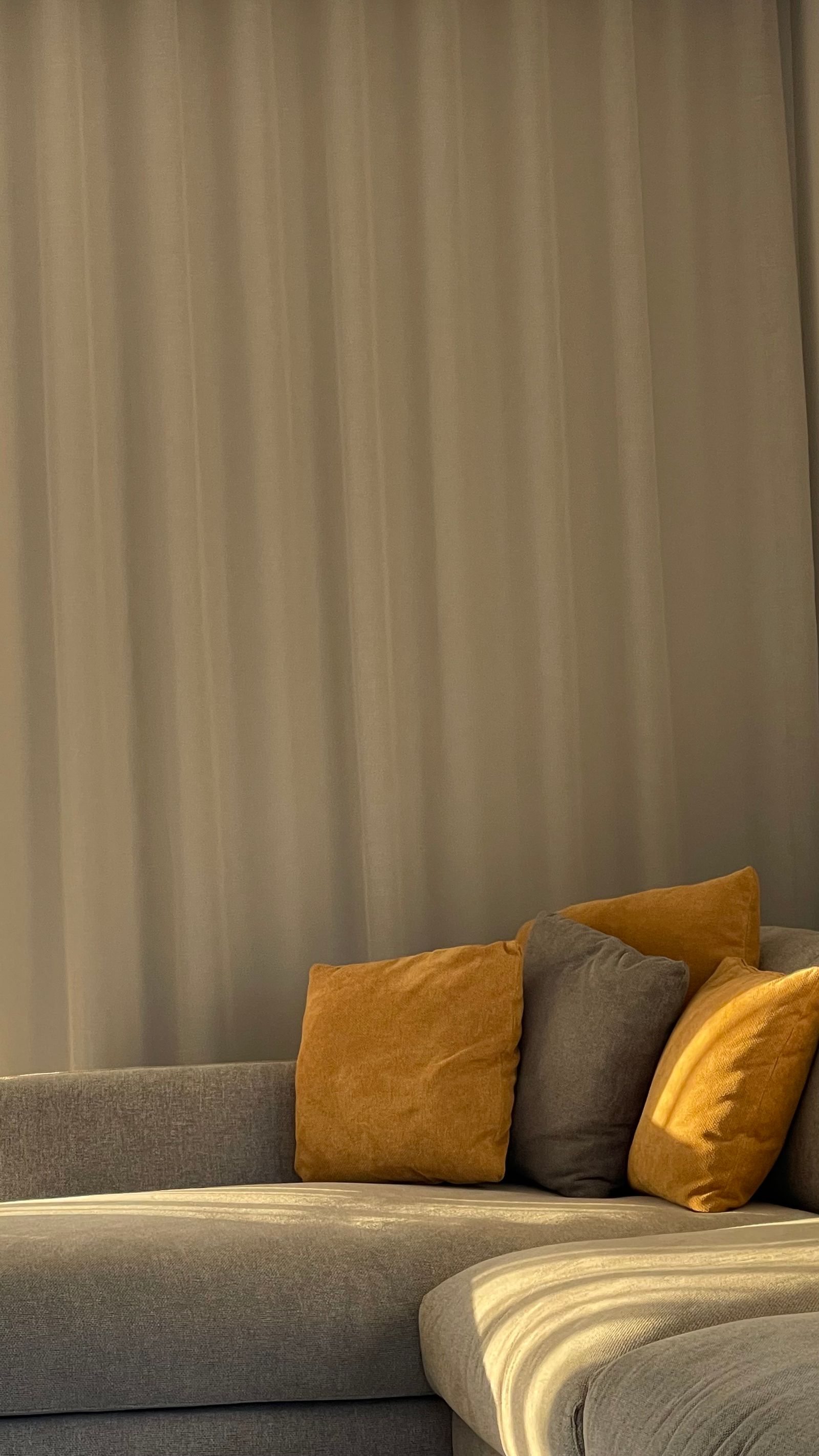 Modern living room with sunlight filtering through sheer curtains