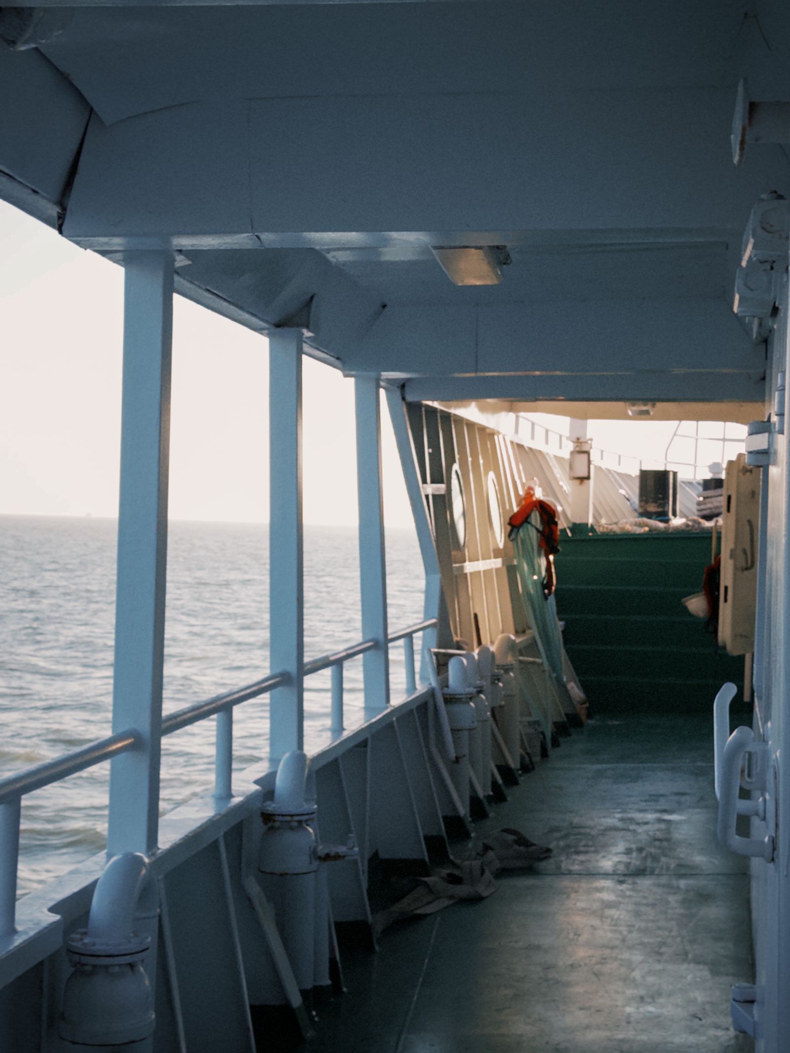 Quiet view along a cruise-ship deck looking out to open ocean