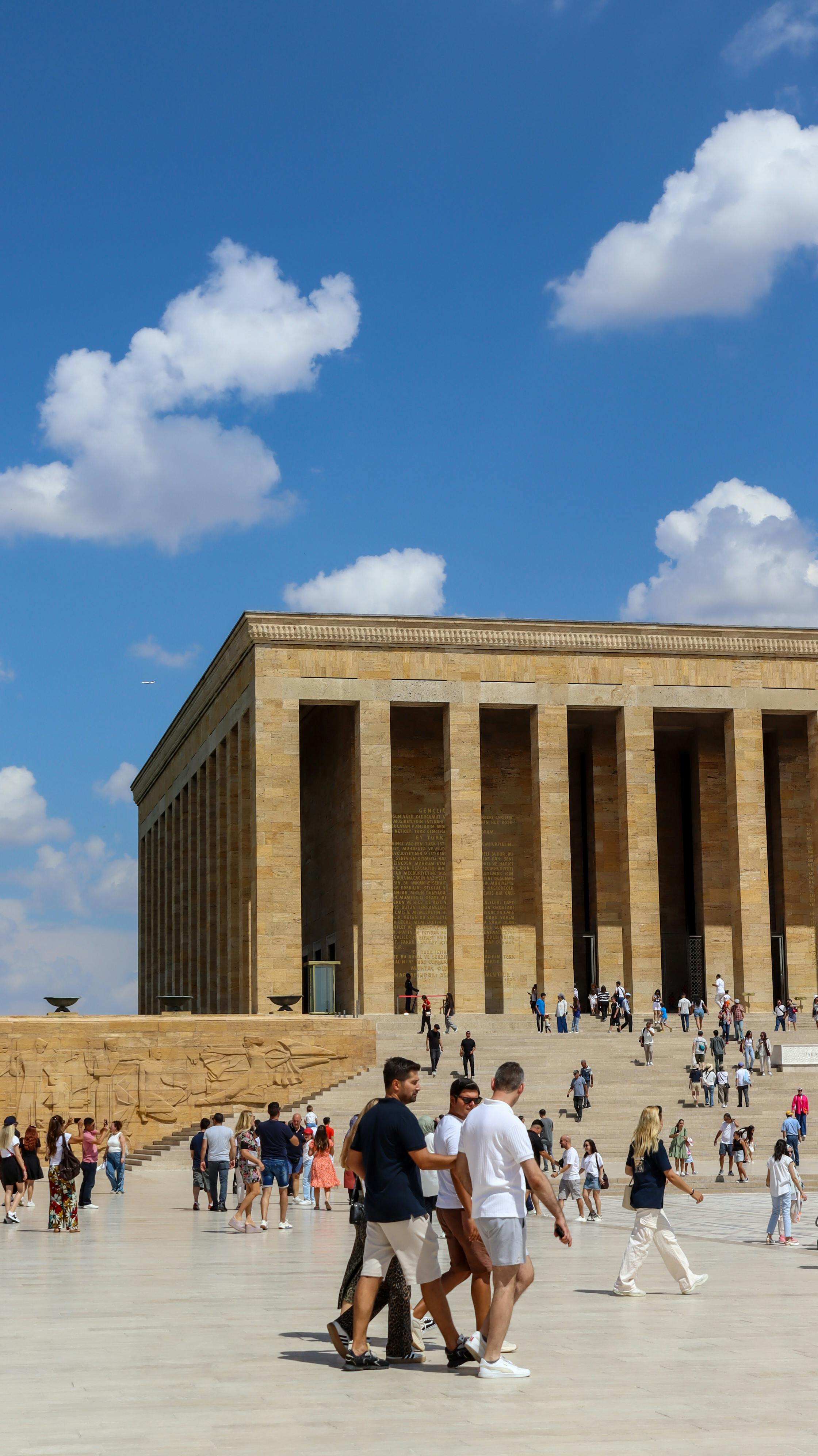 Tourists exploring the historic Anıtkabir in Ankara on a sunny day.