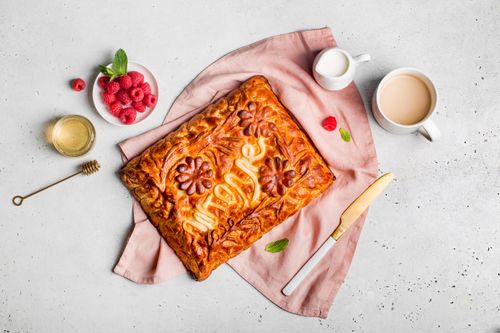 Free Beautifully decorated homemade pie with raspberries and tea for a delightful breakfast. Stock Photo