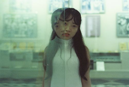 Free Creative portrait of a woman with reflective effects captured indoors, blending subjects and moods. Stock Photo