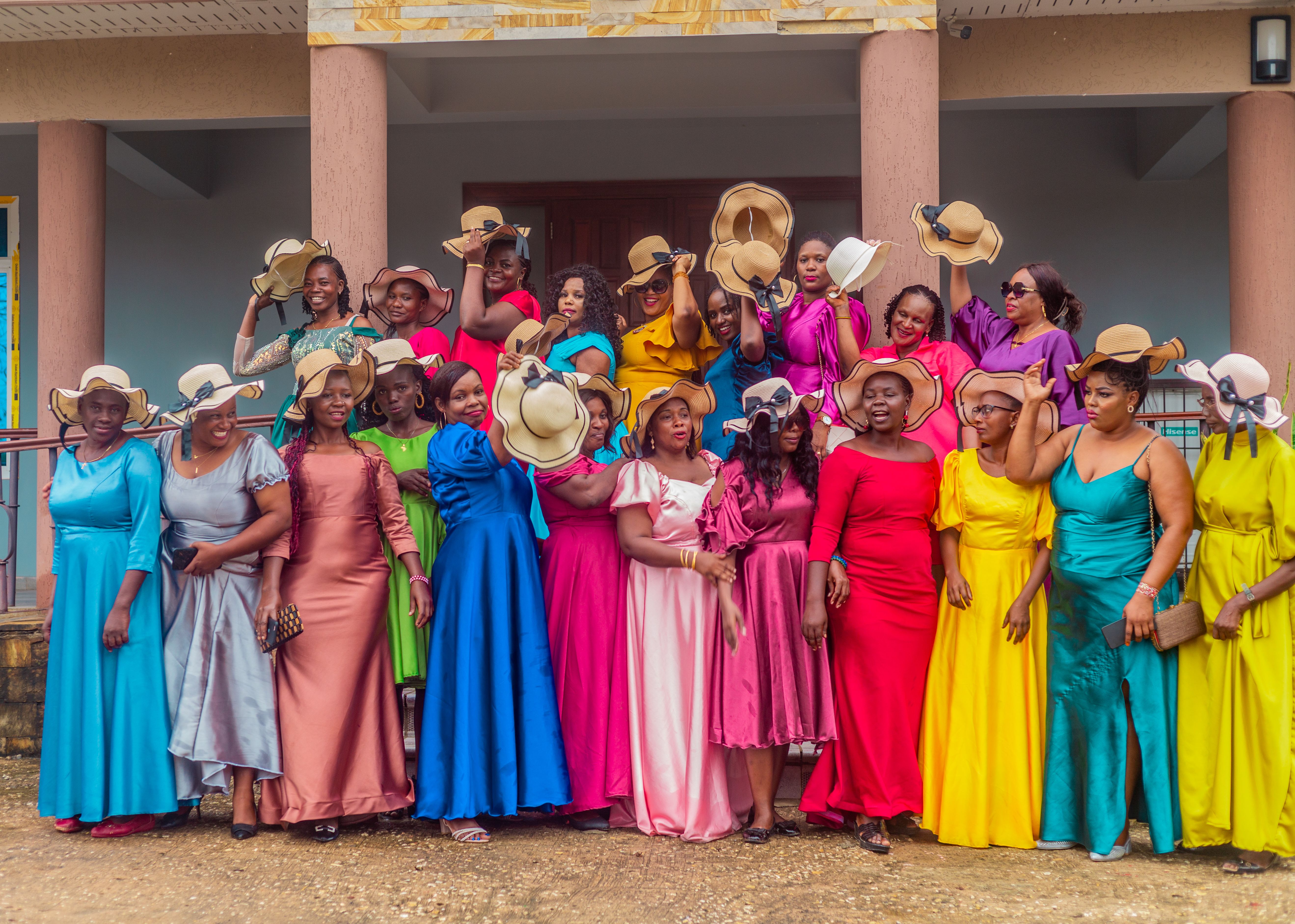 A Group of Women Wearing Colorful Dresses and Hats · Free Stock Photo