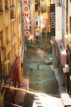 Street view in Beyoğlu, Istanbul featuring a man walking under signs and graffiti walls.
