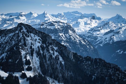 Stunning view of a snow-covered mountain range under a clear blue sky, perfect for winter adventure.