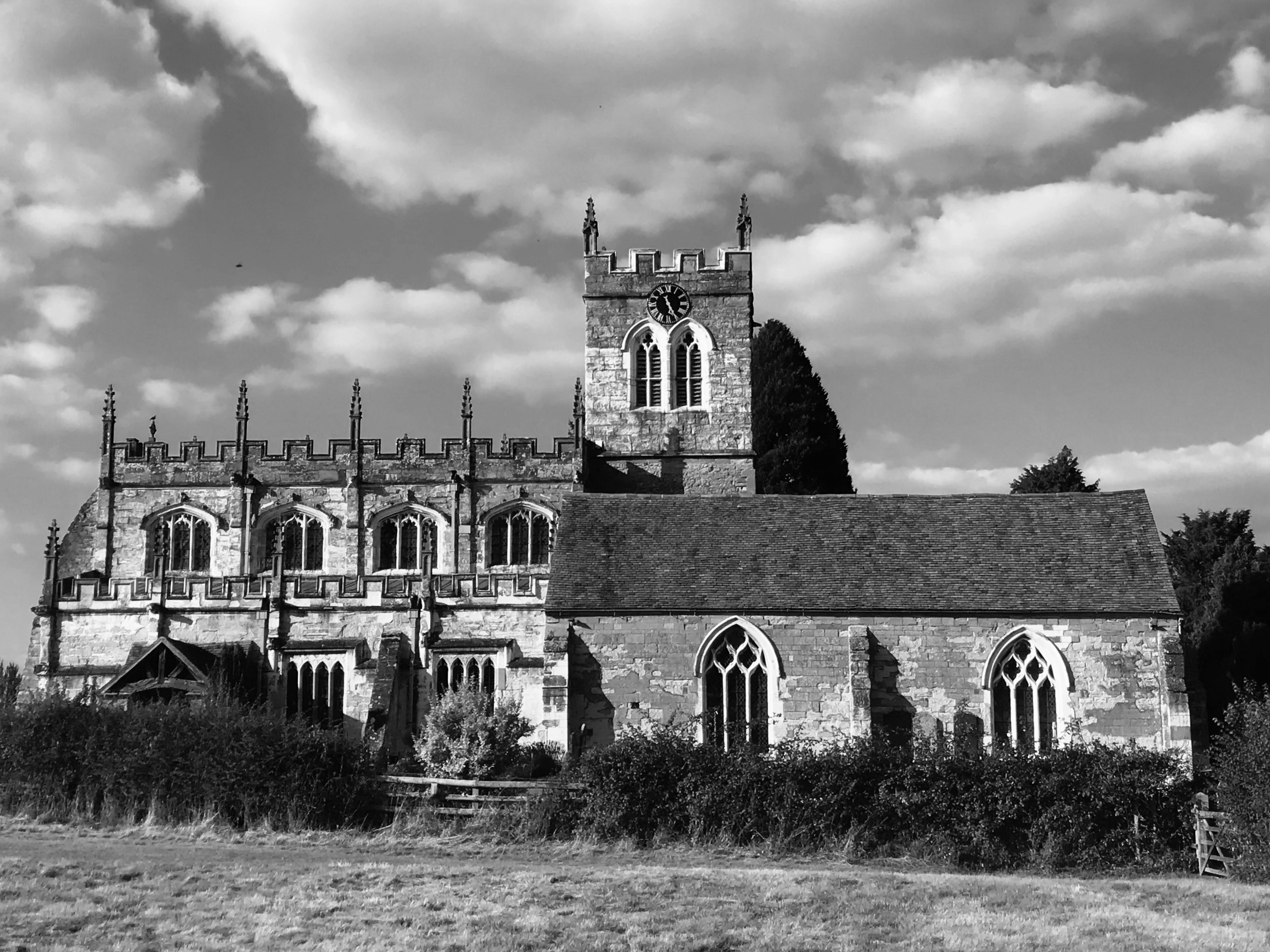 Black and white photo of a Gothic church in Henley-in-Arden, England, showcasing classic architecture.