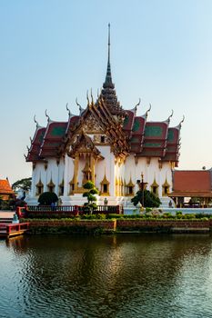 Serene view of a traditional Thai temple reflecting on a calm lake in Bangkok.