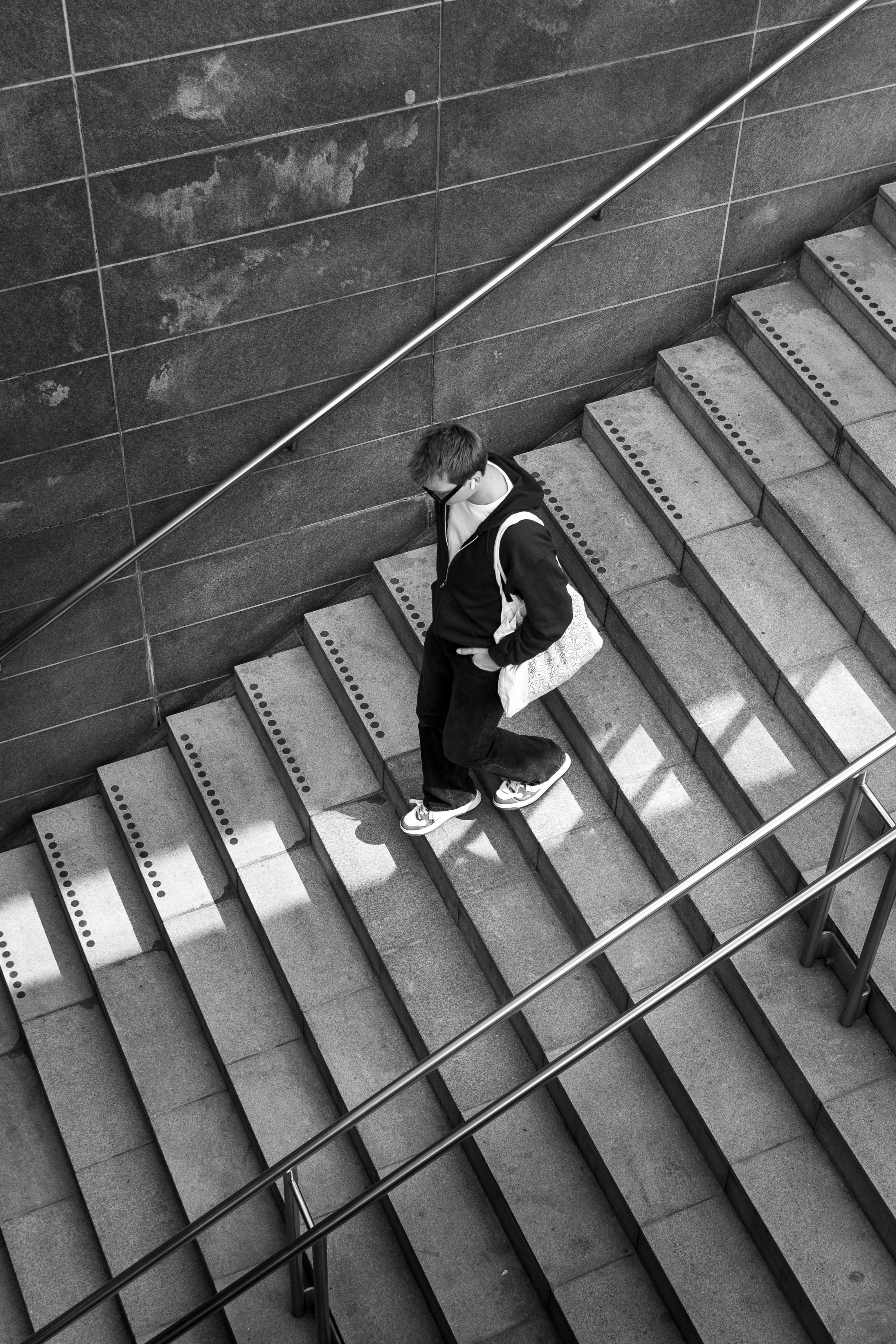 Monochrome view of a person descending a city staircase