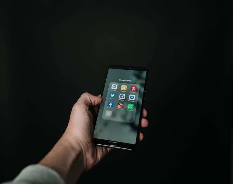 Photo Of Hand Holding A Black Smartphone