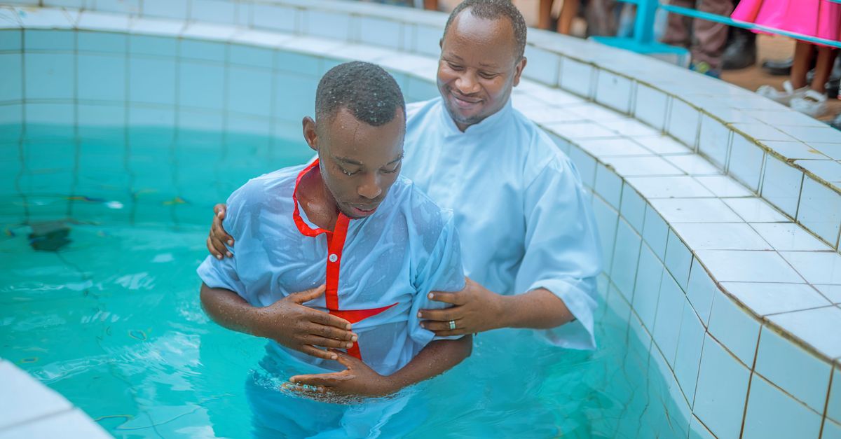 Cérémonie de baptême avec deux hommes dans une piscine, symbolisant la foi et la spiritualité.