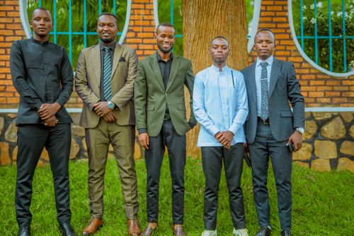 Free A group of five men standing in formal attire outdoors, showcasing confidence and diversity. Stock Photo