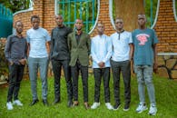 A group of young men standing in front of a brick building