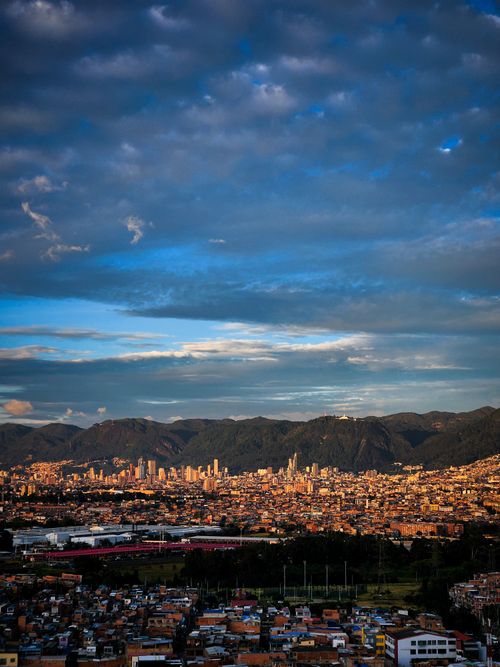 Free Stunning aerial cityscape of Bogota, Colombia, with dramatic clouds and mountains in the background. Stock Photo