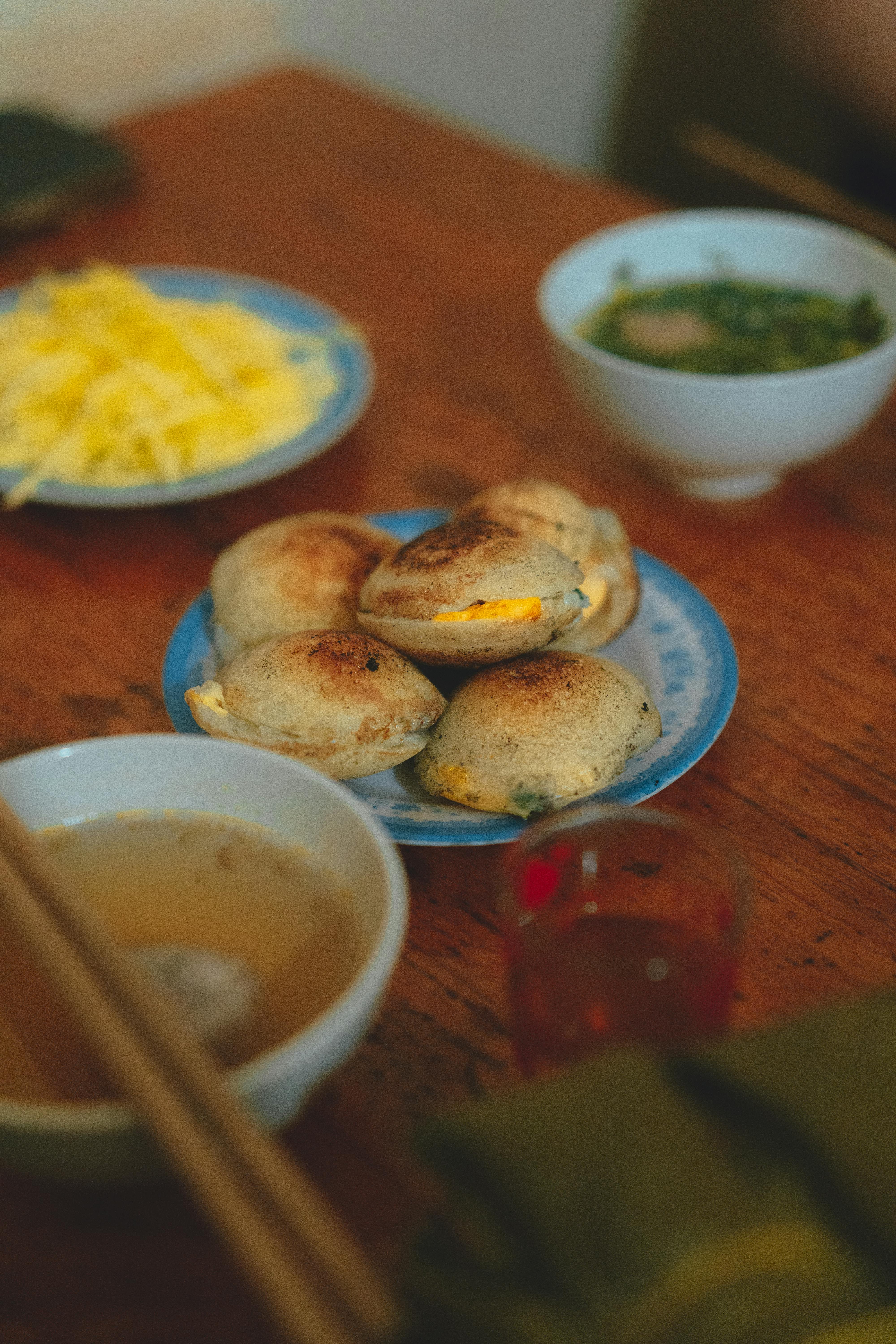 a table with food and bowls of soup