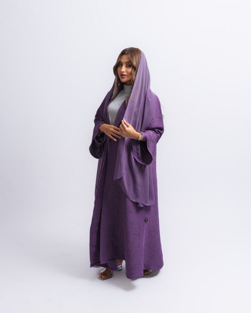 Free Studio shot of a woman in a purple dress and headscarf on a white background. Stock Photo