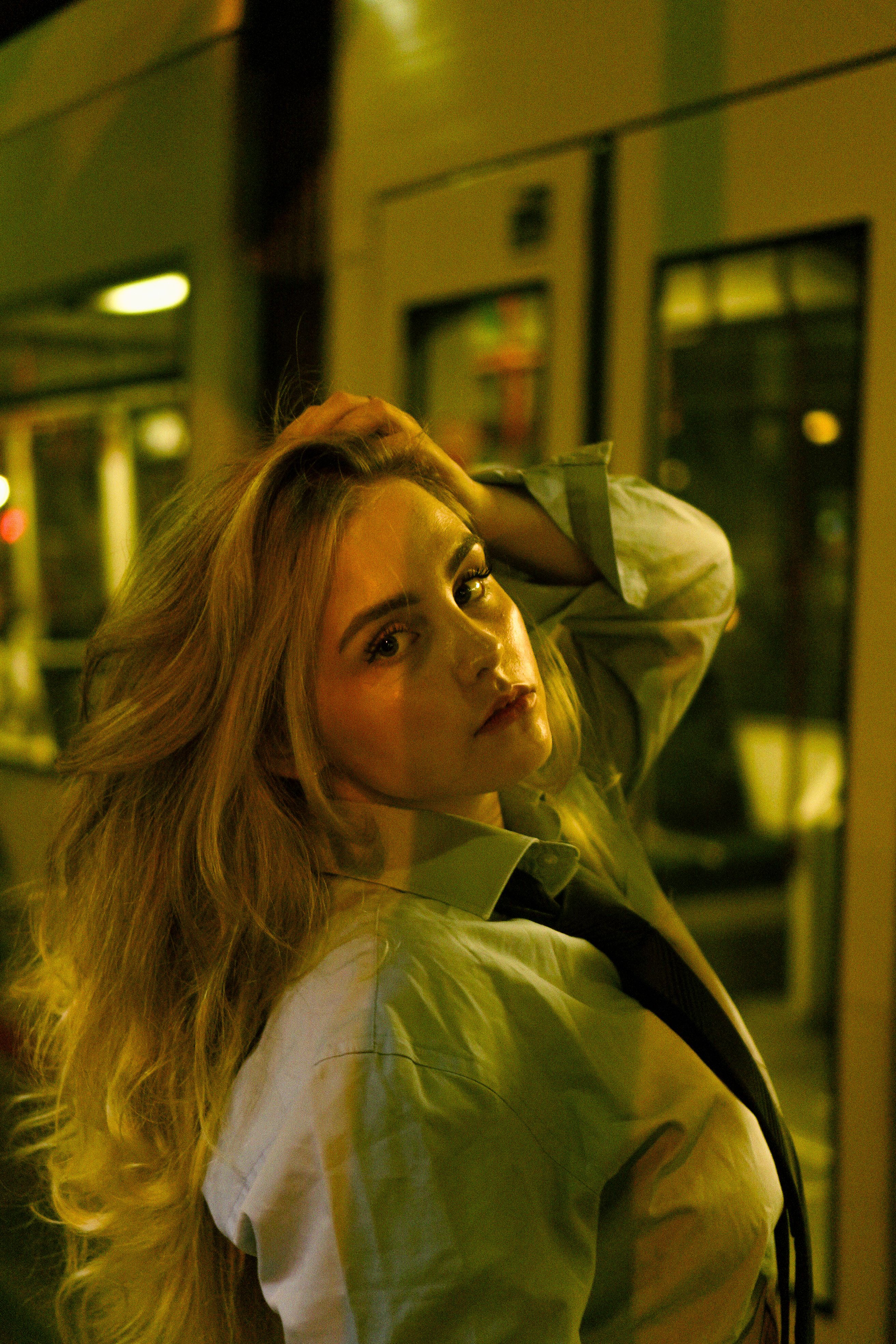 A woman with long blonde hair posing in front of a train · Free Stock Photo