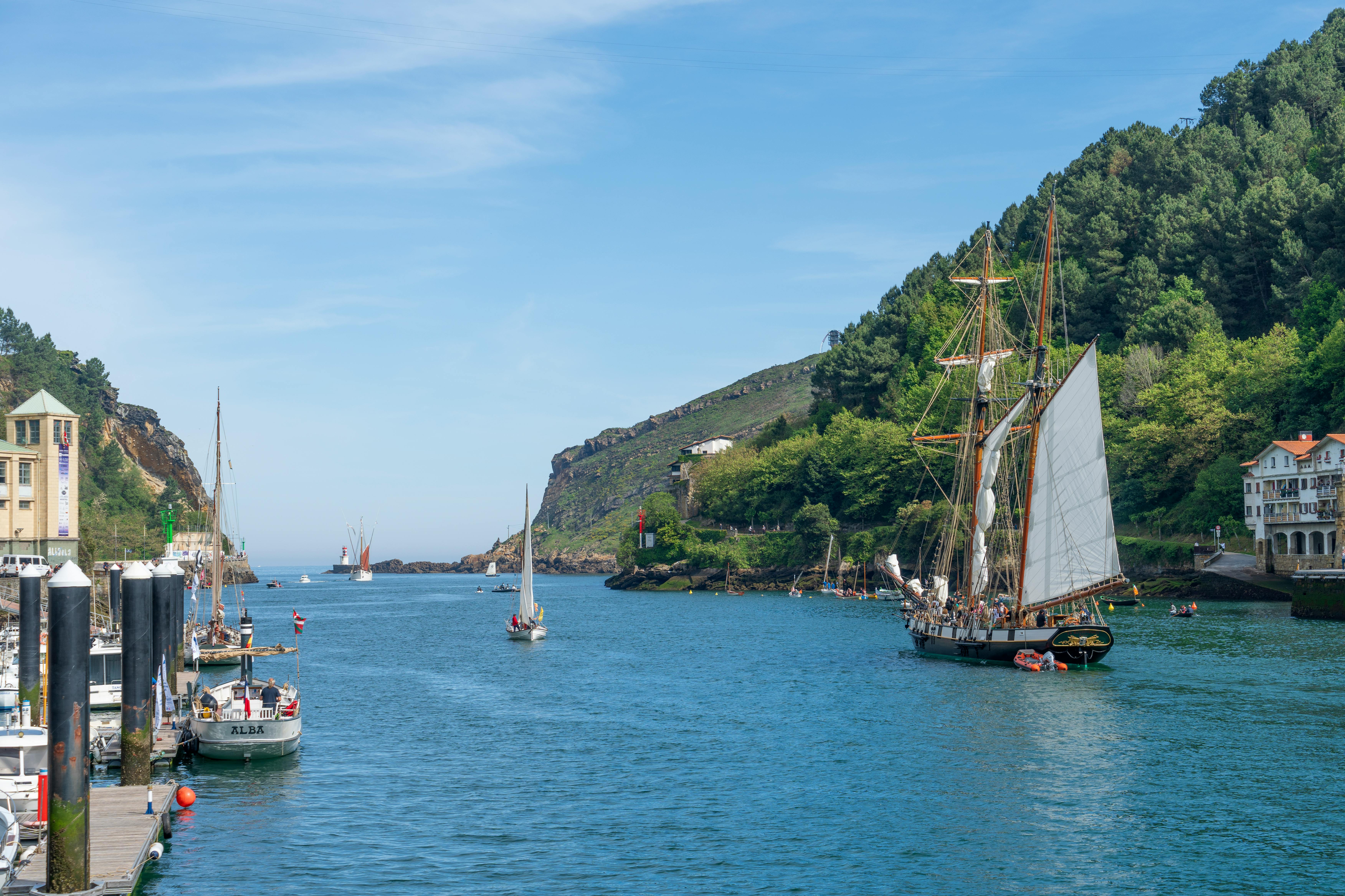 a boat is docked in a harbor with a mountain in the background