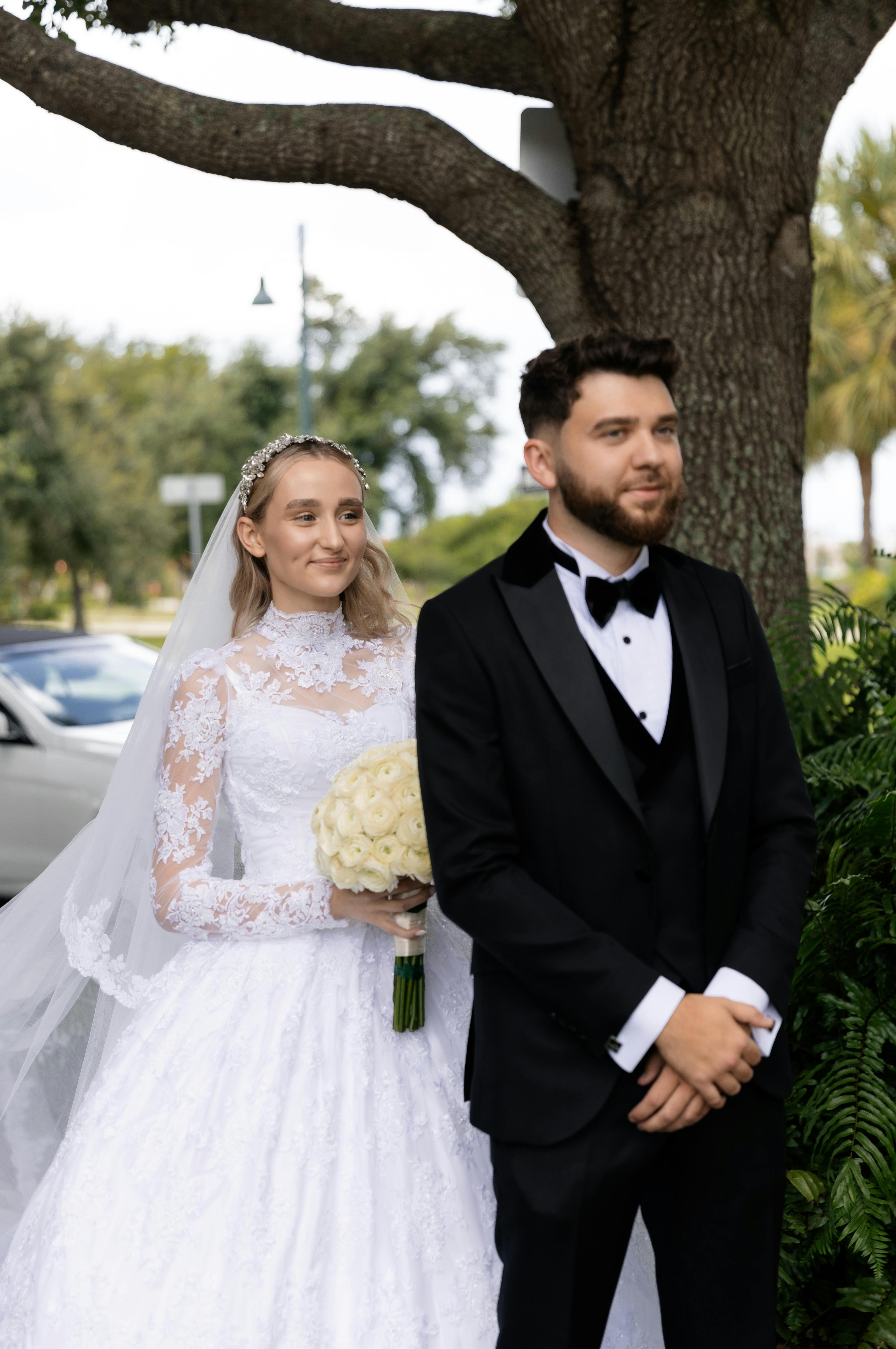 A beautiful bride and groom sharing a romantic moment on their wedding day outdoors.