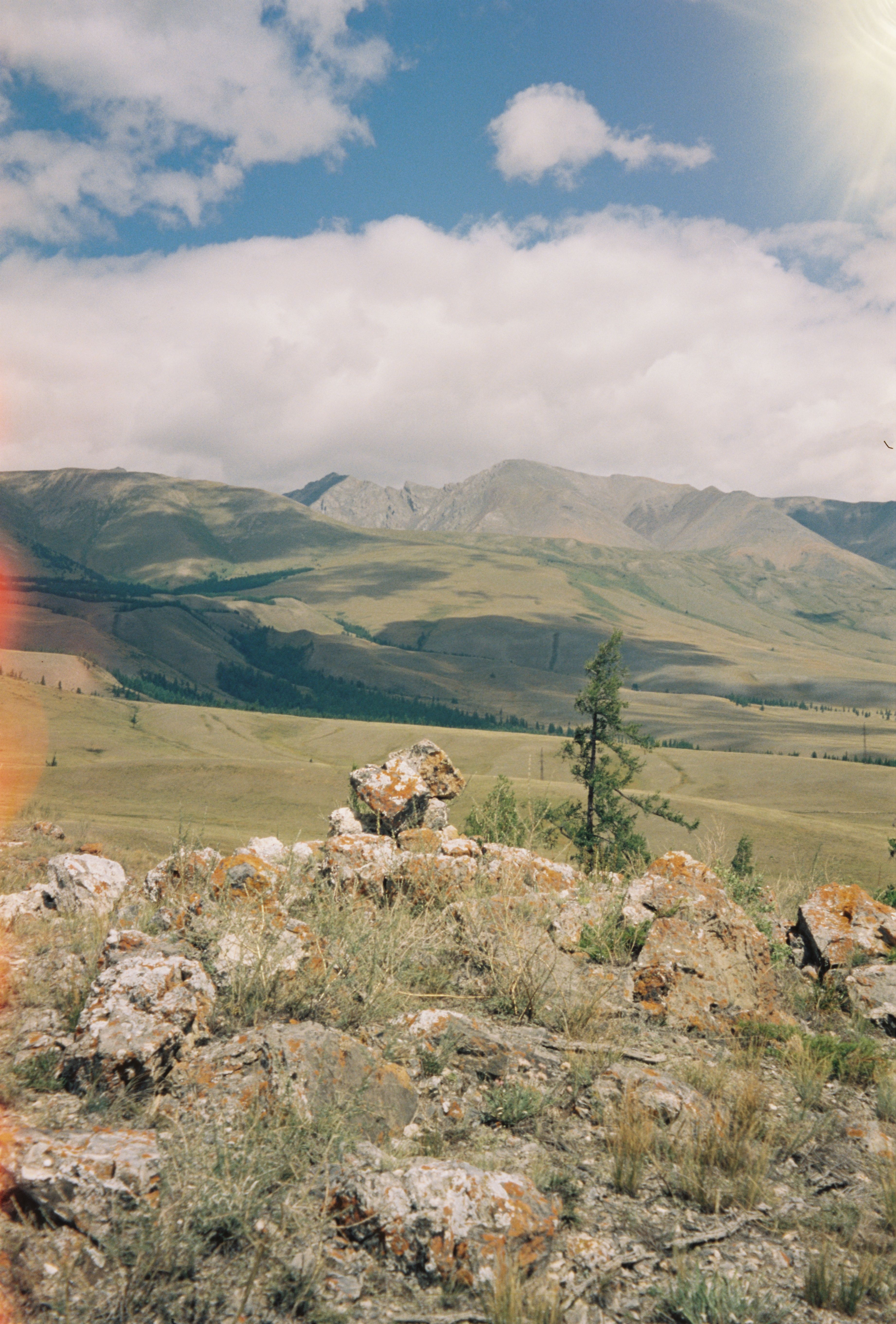 A photo of a rocky landscape with mountains in the background · Free ...