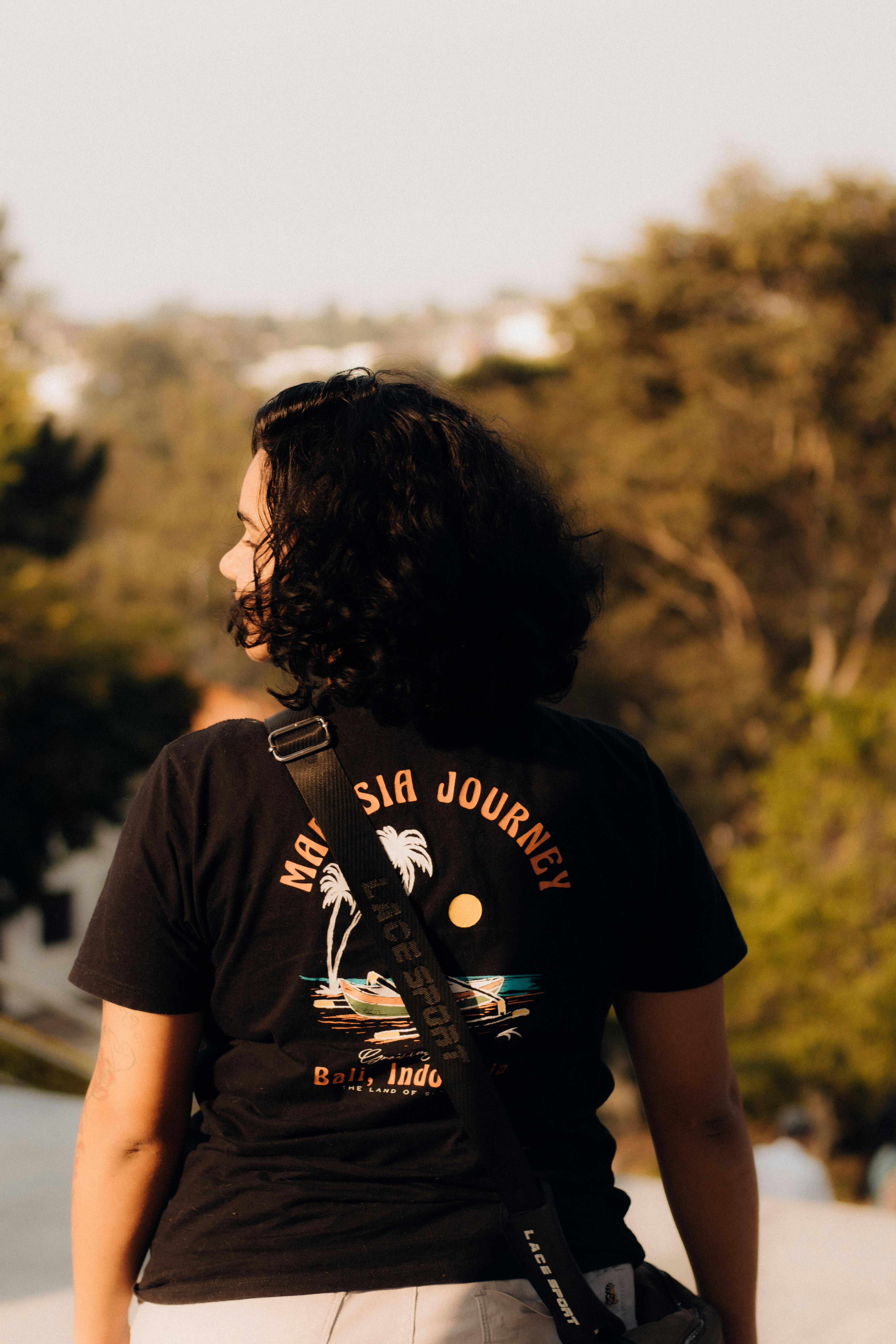 a woman wearing a black shirt and backpack