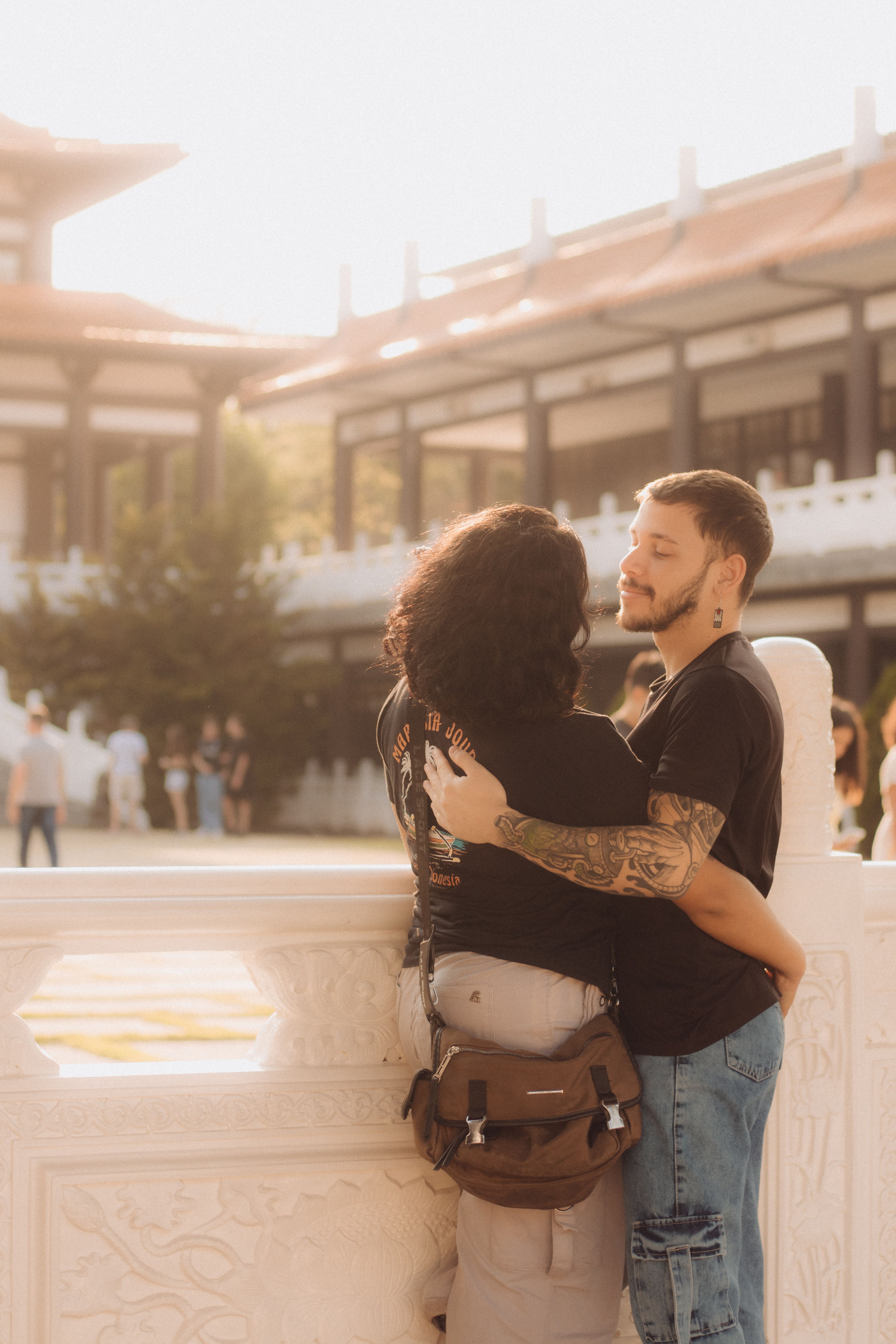 A couple hugging in front of a building · Free Stock Photo