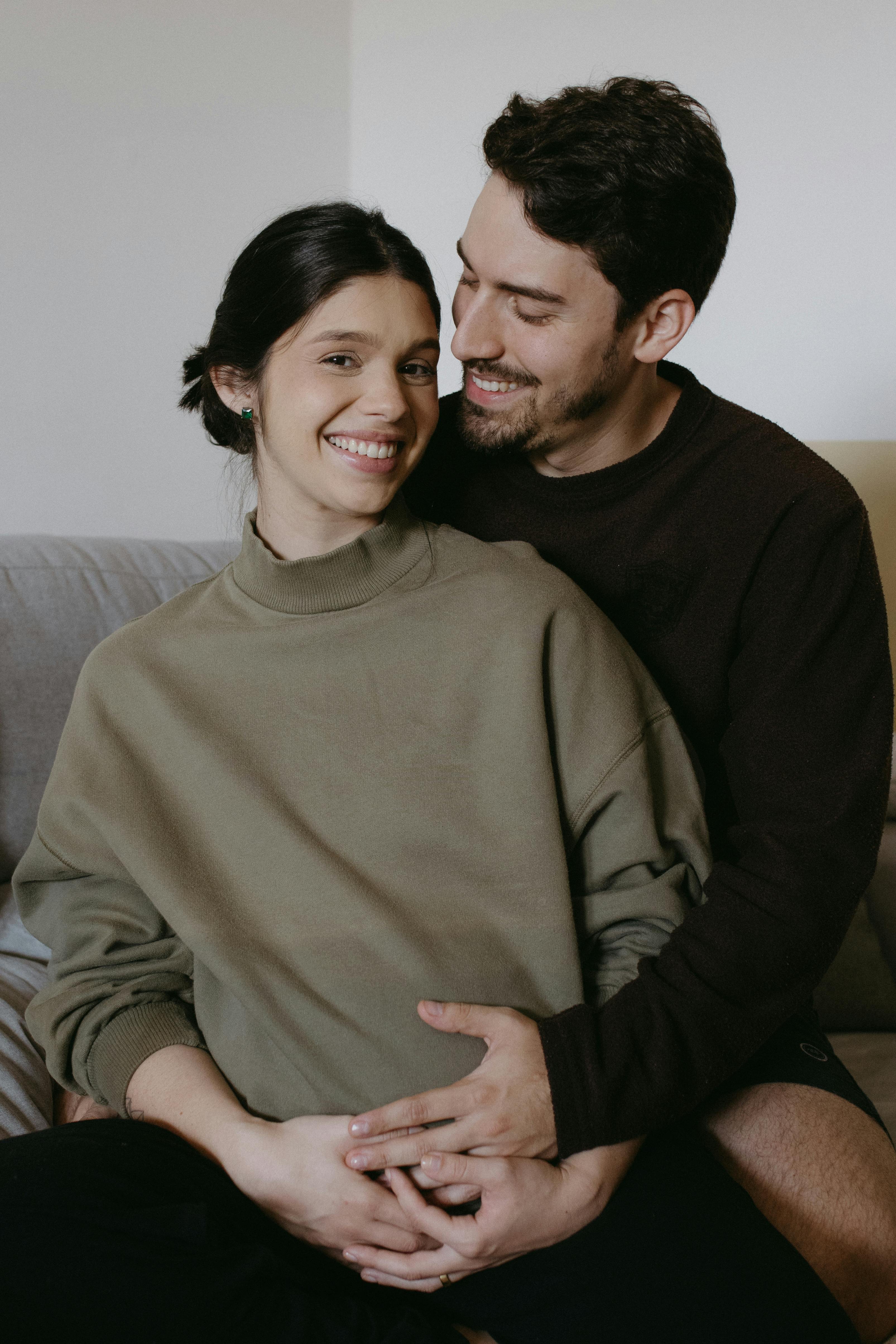 a man and woman are sitting on a couch together