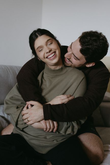 Joyful couple sharing a tender moment in a cozy setting.