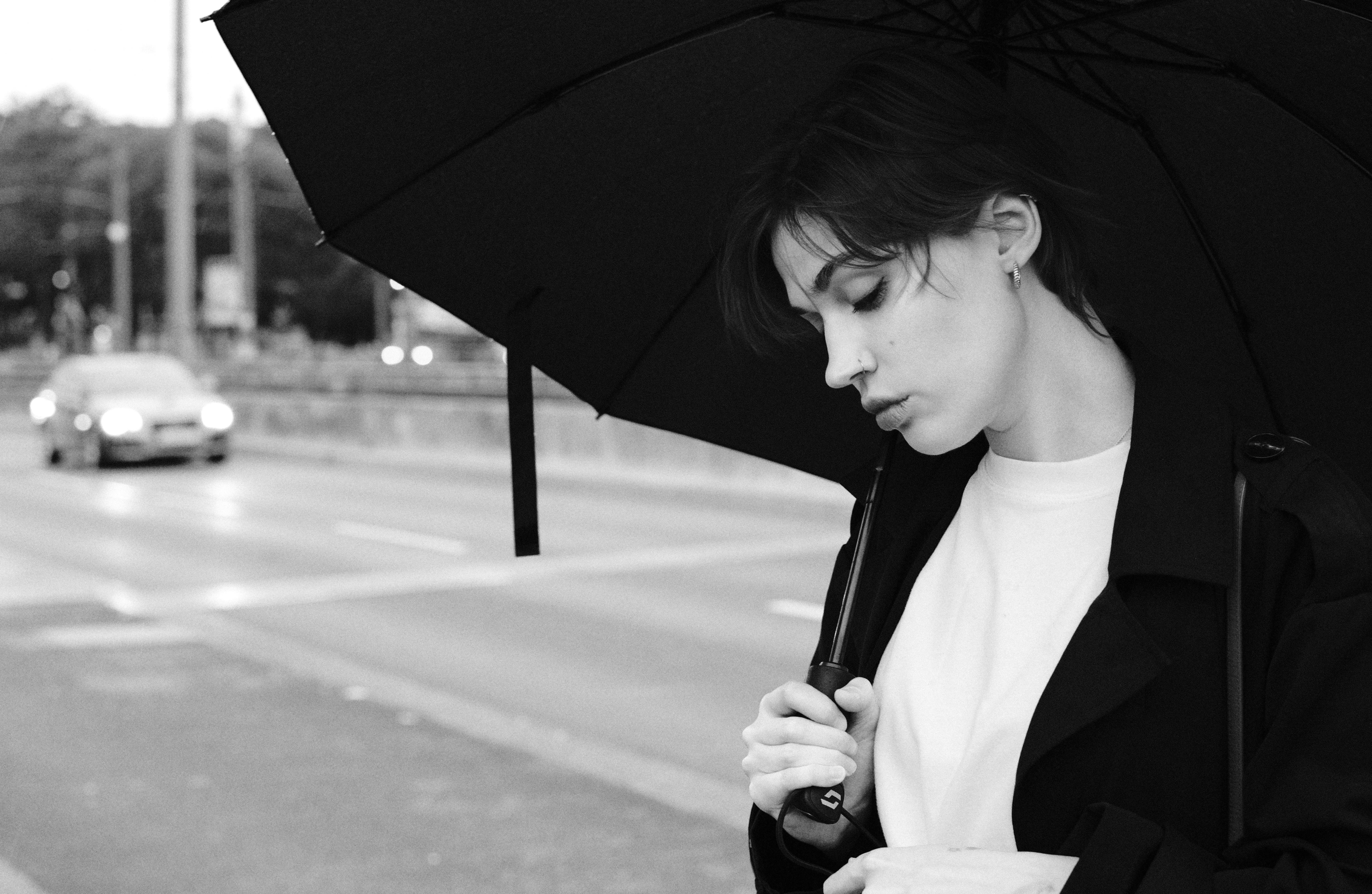 a woman with an umbrella standing on the street