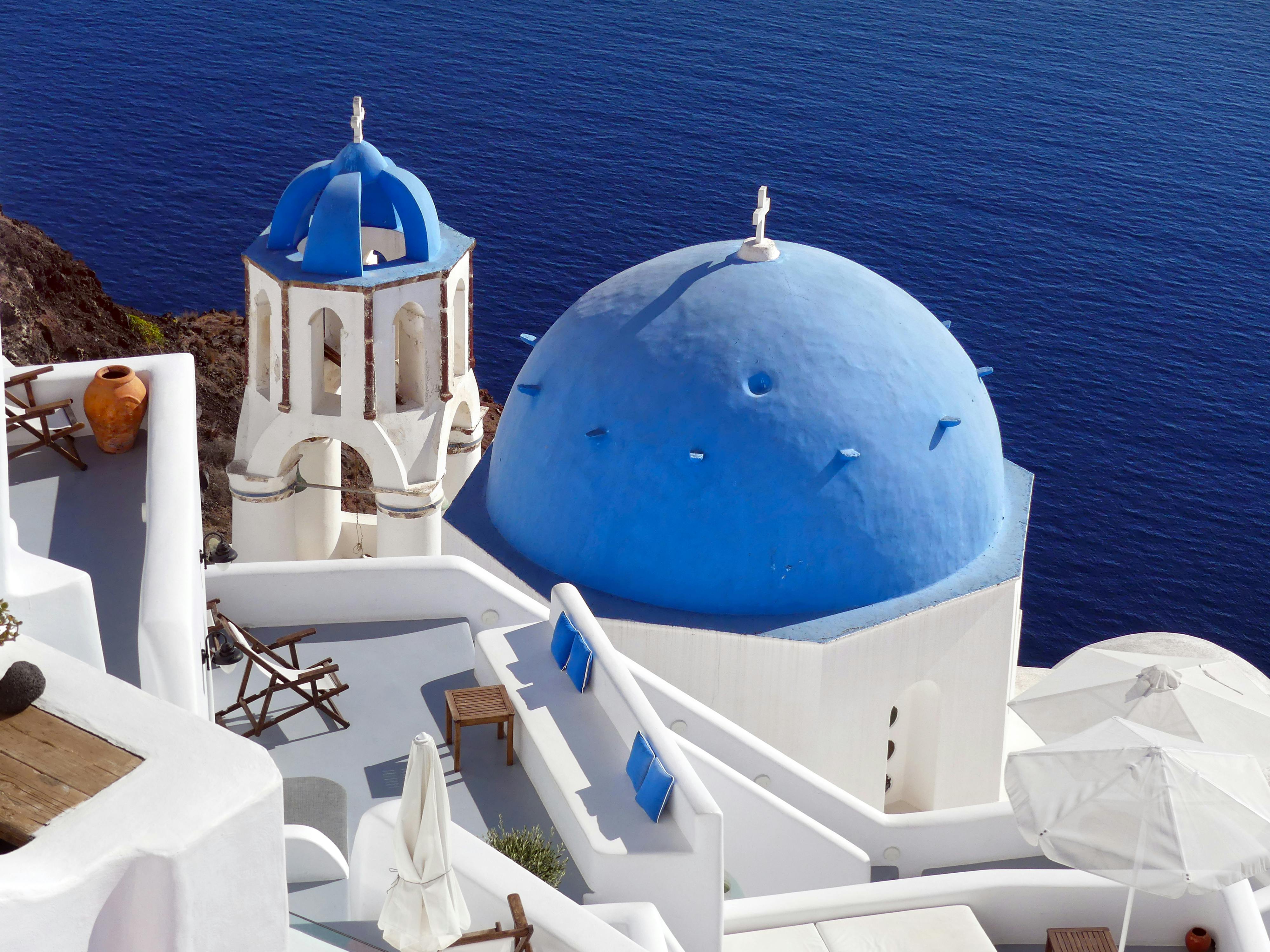 A stunning view of Santorini's blue domes and white buildings overlooking the sea.