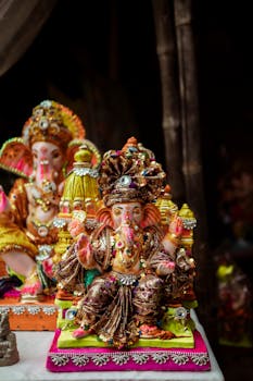 Vibrant statues of Hindu deity Ganesh adorned for a cultural festival.