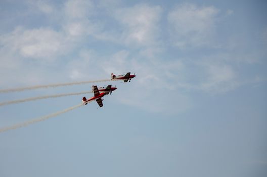 View of Airplanes Flying against a Blue Sky at an Airshow 