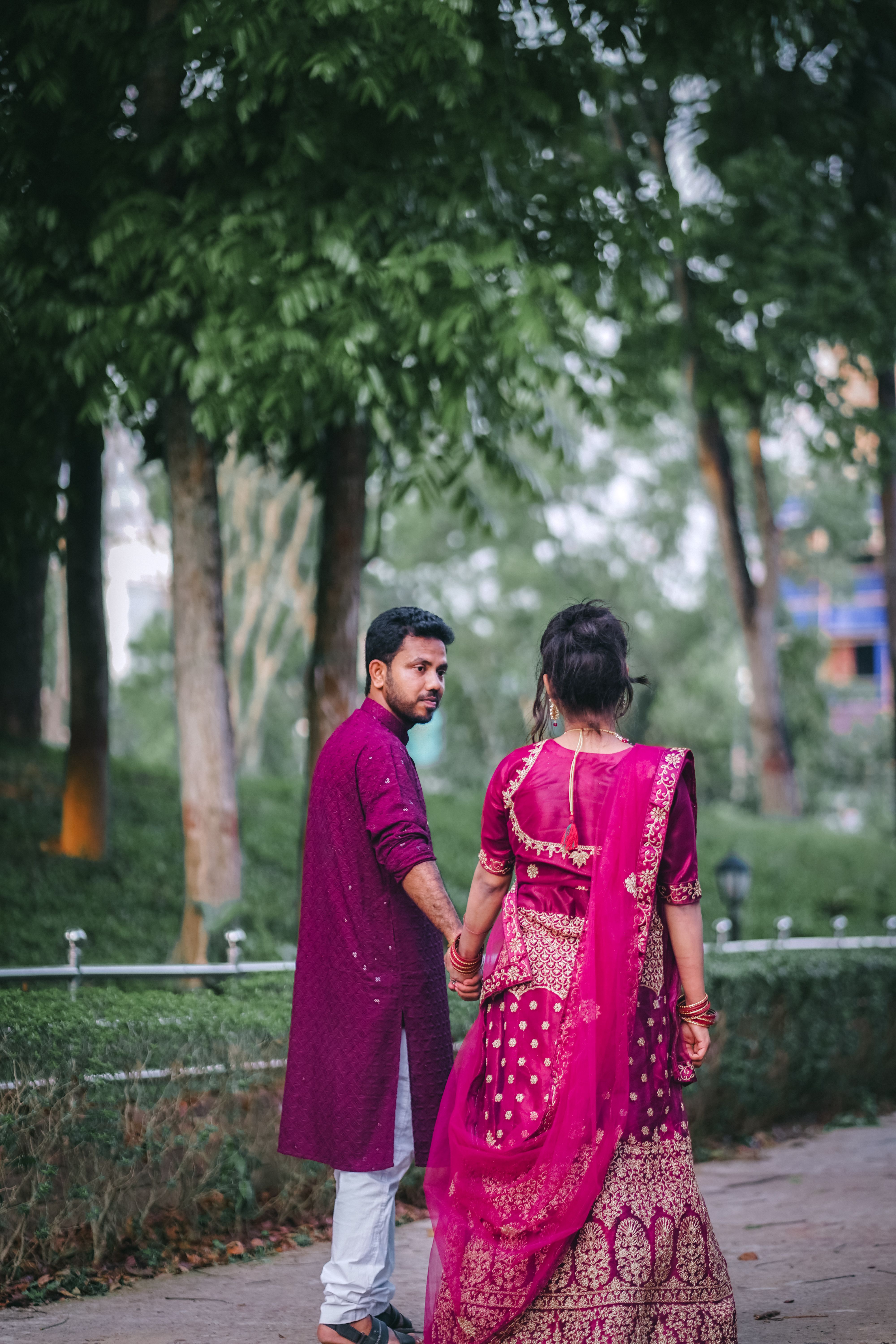A couple in traditional indian attire walking down a path · Free Stock ...