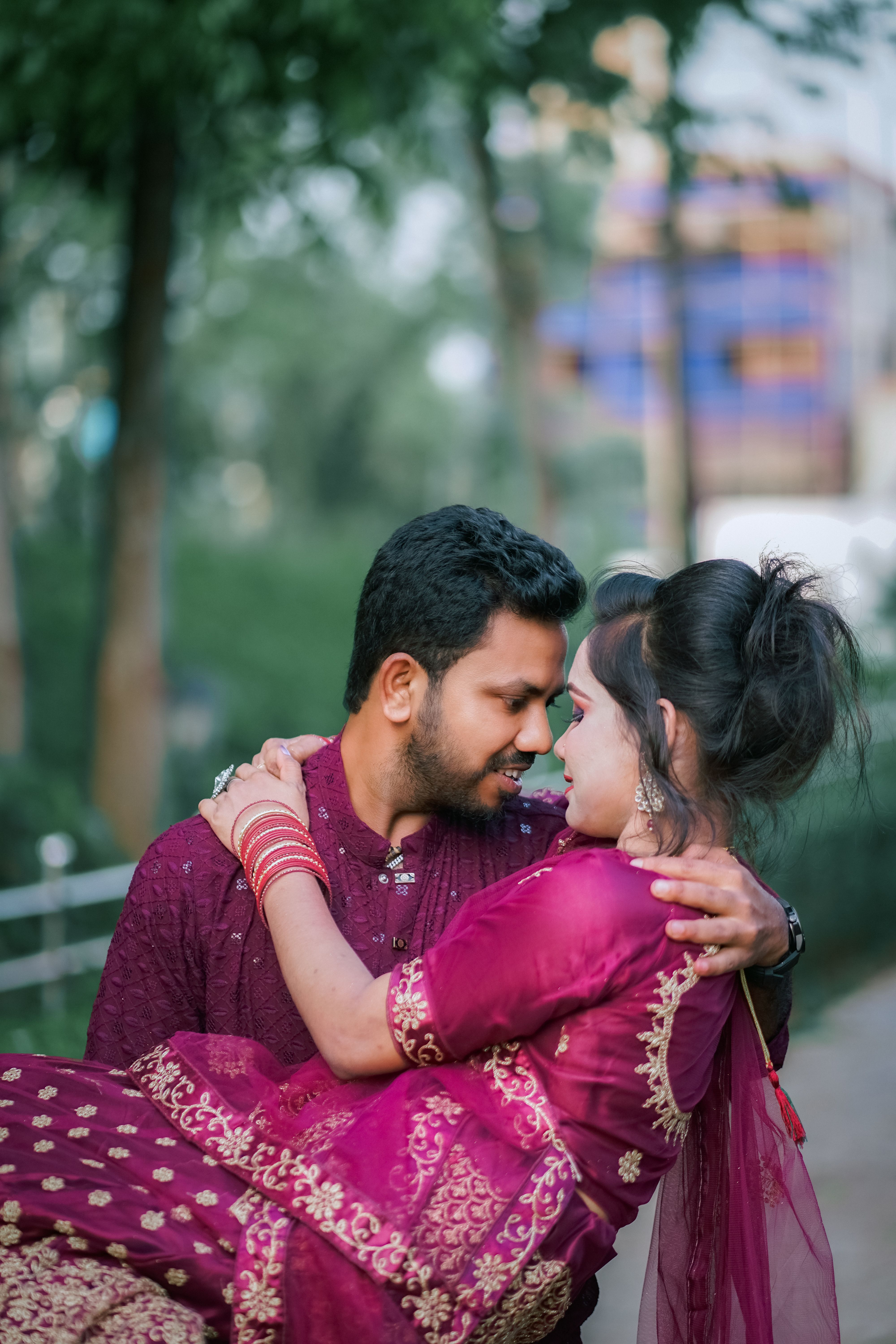 A couple in traditional attire hugging each other · Free Stock Photo