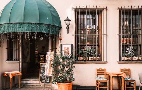 Cozy Istanbul cafe with tables and greenery, inviting for brunch or coffee.