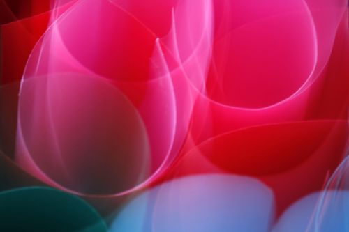 Free Dynamic abstract artwork featuring vibrant red, pink, and blue swirling patterns. Stock Photo