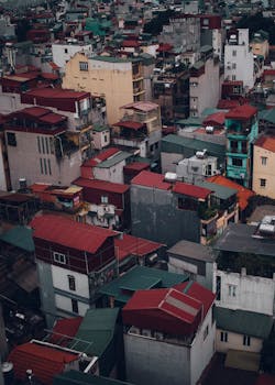 Aerial view of colorful rooftops and dense urban architecture in Hanoi, Vietnam.