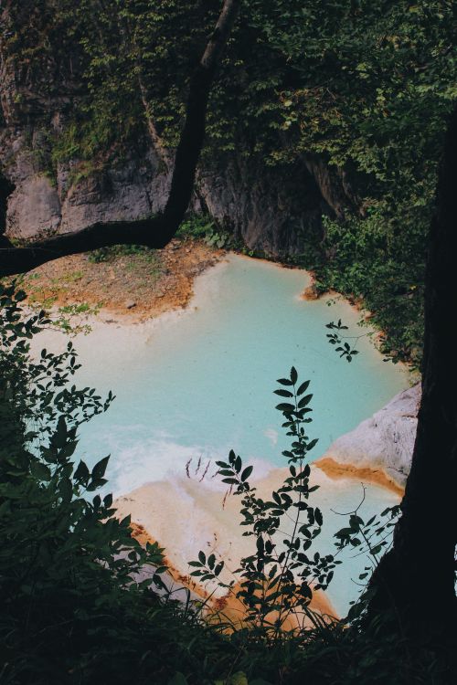 Free A stunning natural cascade with turquoise water surrounded by lush greenery, perfect for adventure seekers. Stock Photo
