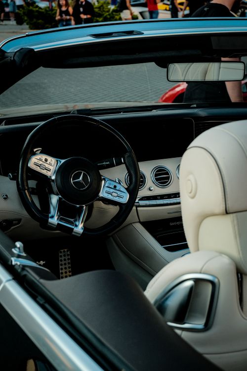 Free Detailed view of a luxury convertible's dashboard and steering wheel, emphasizing elegance. Stock Photo
