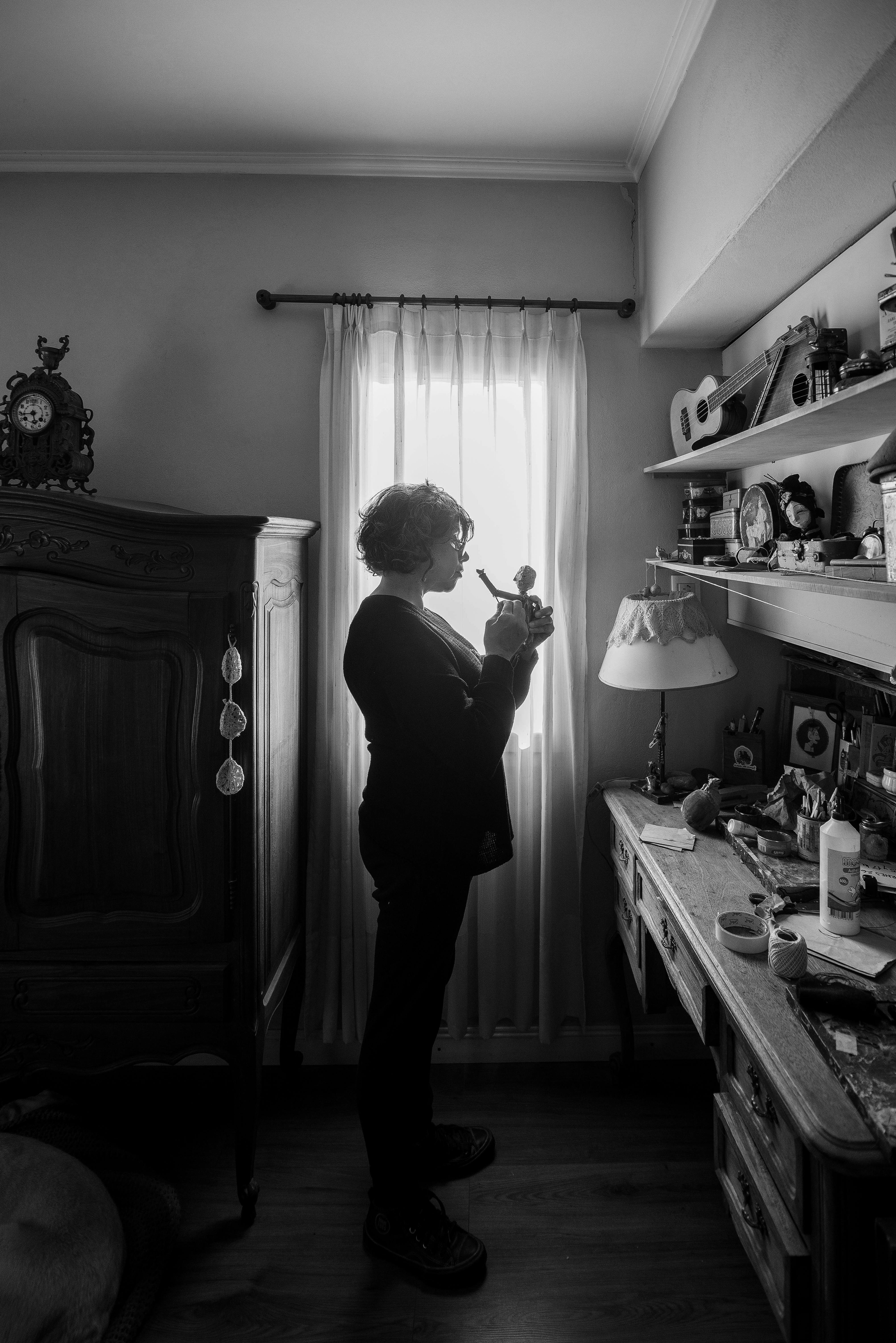 a woman is standing in front of a mirror