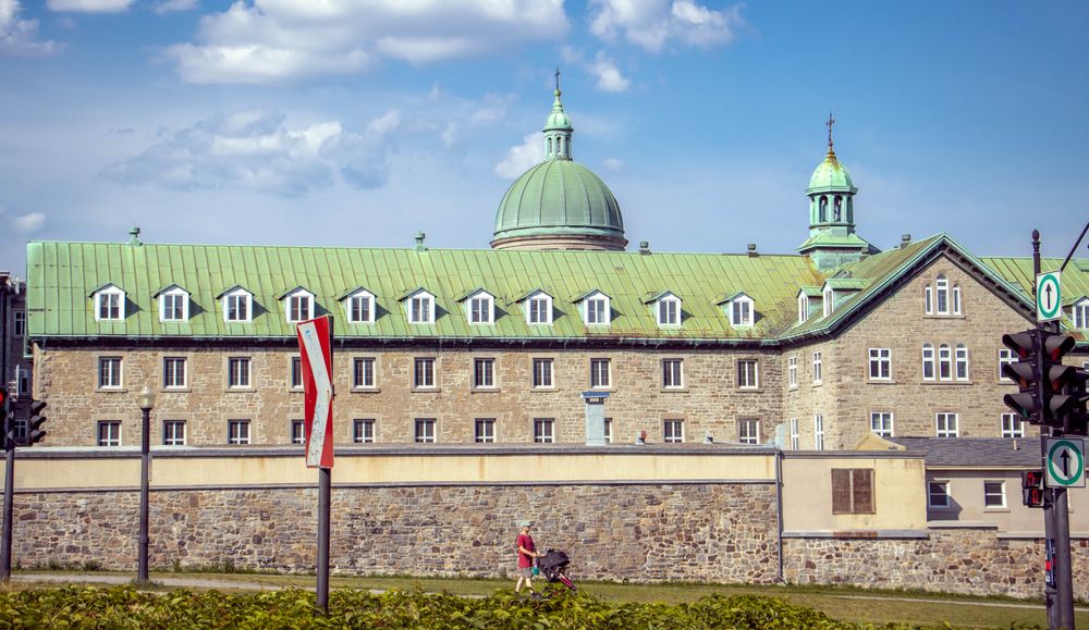 A historic building with domed roofs in Montreal, Quebec, featuring classic architectural style.