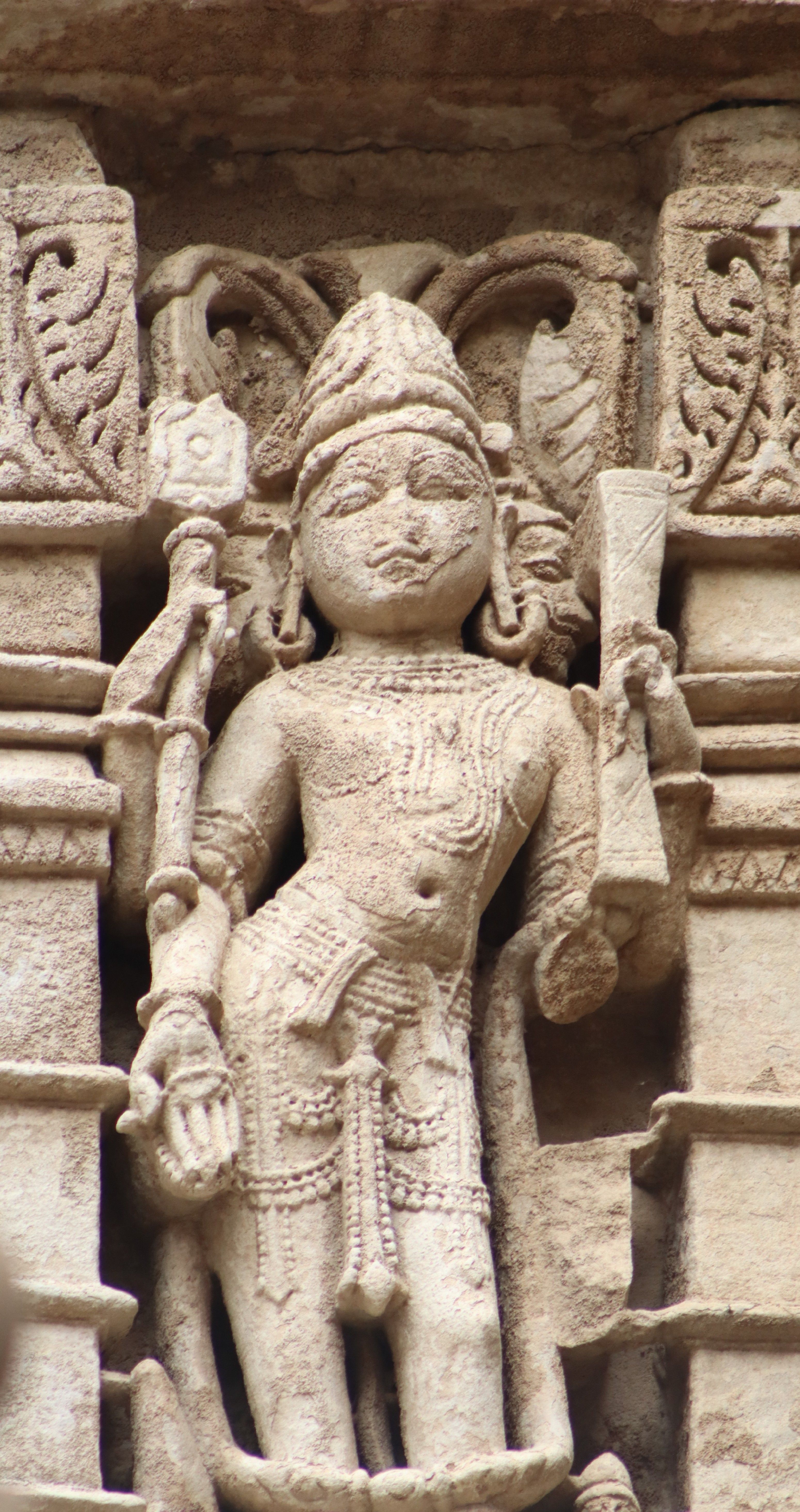 Detailed stone sculpture depicting a deity, showcasing traditional craftsmanship in sacred temple architecture.