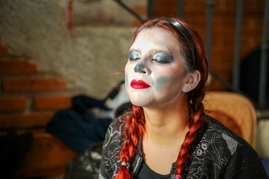 Woman with traditional Catrina makeup in Mexico City, portraying cultural artistry.