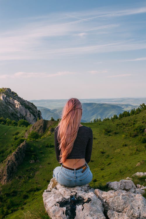 Woman Sitting on Rock