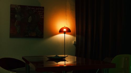 Free Warmly lit room featuring a stylish lamp and contemporary decor, creating a cozy ambiance. Stock Photo