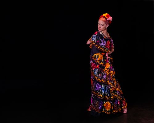Free Colorful Mexican traditional dress worn by a dancer in a studio setting. Stock Photo
