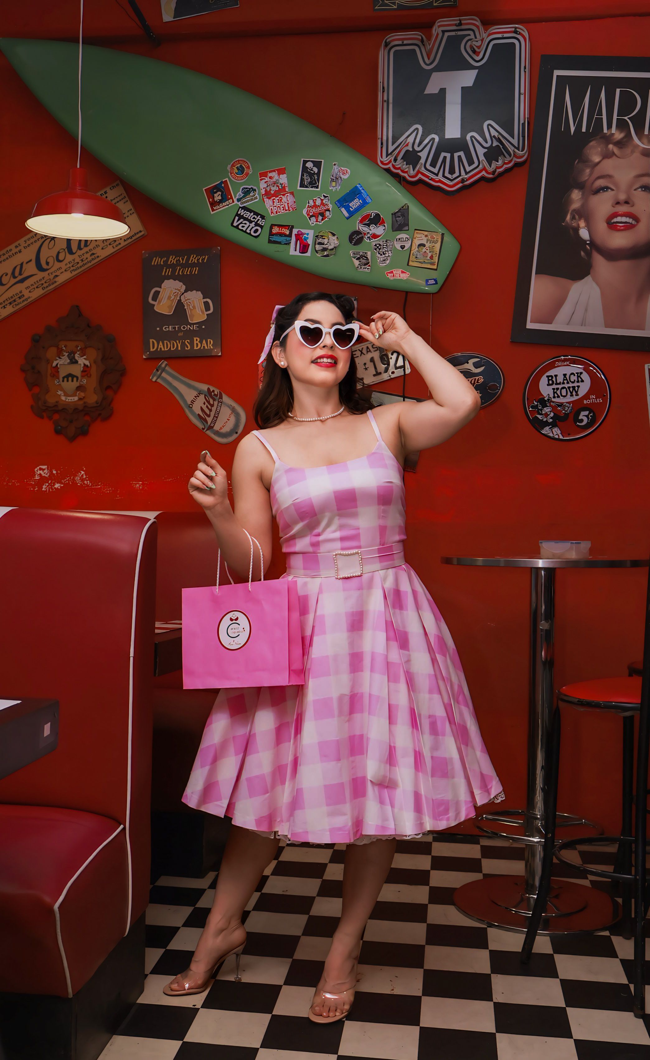 Brunette Woman in Pink Dress Posing in Retro Restaurant  Free Stock Photo