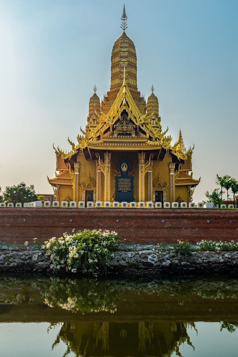 Golden Buddhist temple in Bangkok at sunset