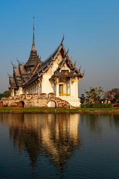 A beautiful Buddhist temple reflecting in water in Bangkok, Thailand during the day.