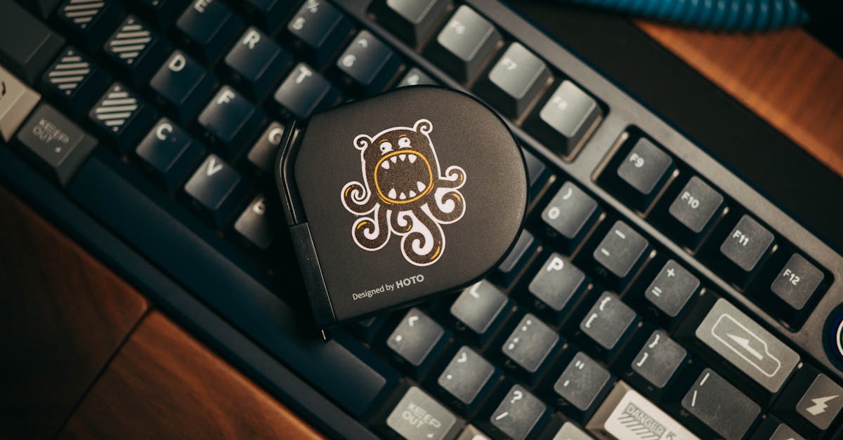 Close-up of a custom mechanical keyboard with a stylish gadget on top, showcasing modern design.