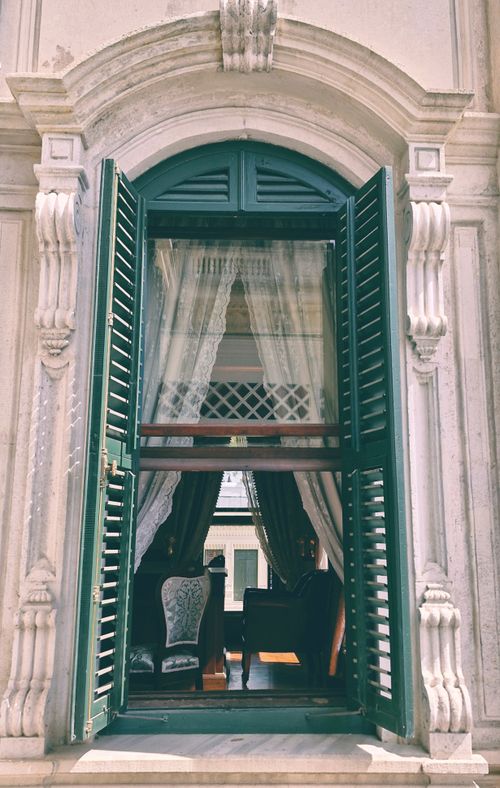 Free Elegant green wooden window with curtains in an ornate Istanbul building facade. Stock Photo
